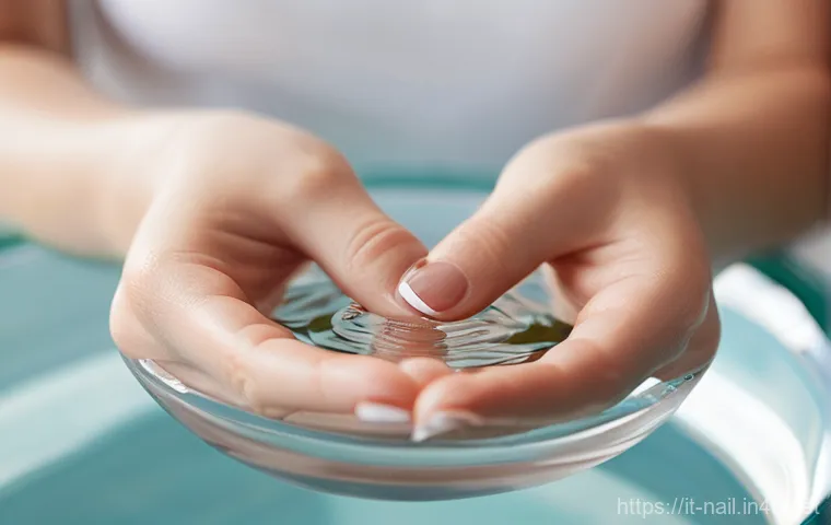 네일 클리퍼와 푸셔 사용법 - **Prompt:** A serene close-up shot of feminine hands gently submerged in a transparent, round bowl o...