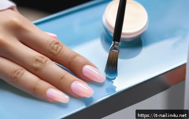 젤 네일 필오프 베이스 장단점 - A close-up image of a well-manicured hand applying peel-off gel nail base with a small brush. The na...